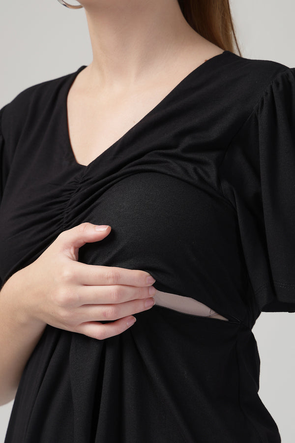 Model wears black Maternity Tops; stylish maternity fit with Zip function.