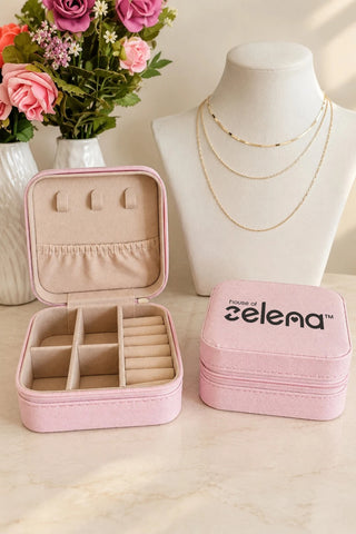 Makeup & Jewellery Organizer Box, lifestyle image: pink box with jewellery compartments on a dresser, zip-around closure