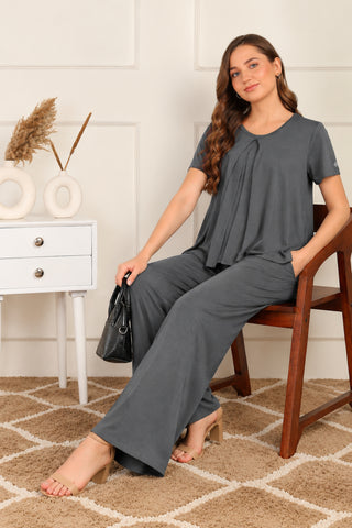 Zipless Top & Maternity Pajama Set in Charcoal Grey, lifestyle image: seated on a chair, relaxed wide-leg fit | Zelena