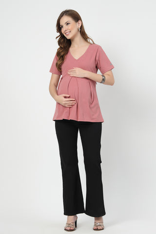 Detail shot of Cotton fabric; shows stretch and pink color/print.