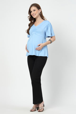 Detail shot of Viscose fabric; shows stretch and sky-blue color/print.