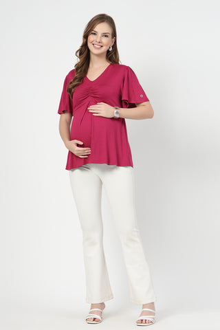 Detail shot of Viscose fabric; shows stretch and onion-pink color/print.