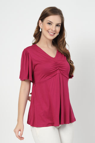 New mom wearing onion-pink Maternity Tops; shows flattering post-delivery fit and Zip.