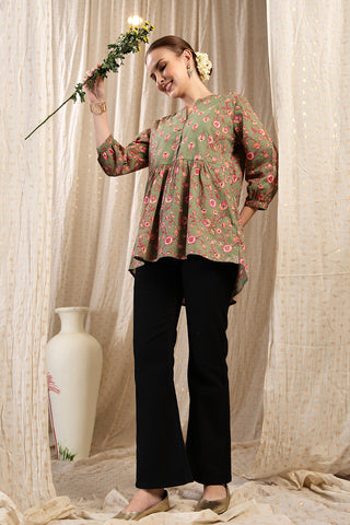 Styling detail of Maternity Zipless Feeding Peplum Top - Sage, highlighting apple-green print and Maternity Tops design.