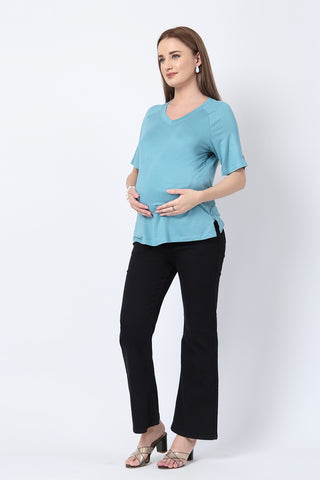 Detail shot of Viscose fabric; shows stretch and light-sea-green color/print.