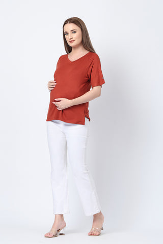 Detail shot of Viscose fabric; shows stretch and rust color/print.