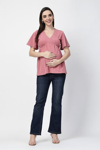 Detail shot of Cotton fabric; shows stretch and pink color/print.