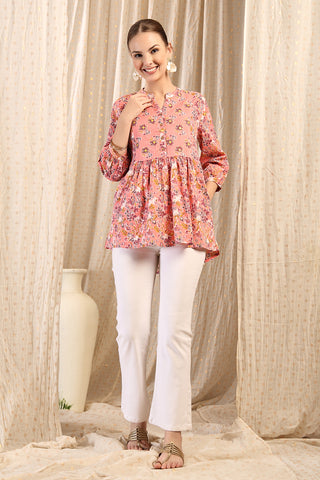 Side or angle view of Maternity Zipless Feeding Peplum Top - Peach showing the Maternity Tops silhouette and fit.