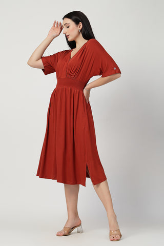 Woman wearing Rust Solid Smocked Waist Zipless Feeding Dress in Stylish - Pre & Post Pregnancy
