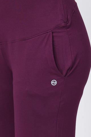 Model wearing Deep Burgundy Pants; high waist panel offers abdomen support during phases.