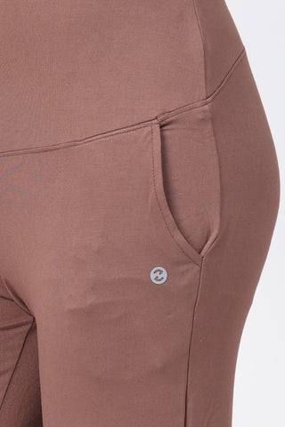 Model wearing Mocha Flared Pants; high waist panel offers abdomen support during phases.