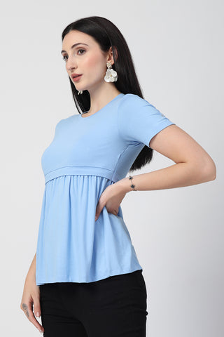 Detail shot of Viscose fabric; shows stretch and aqua-blue color/print.