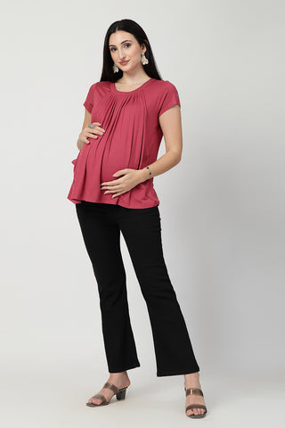 Detail shot of Viscose fabric; shows stretch and dusty-pink color/print.