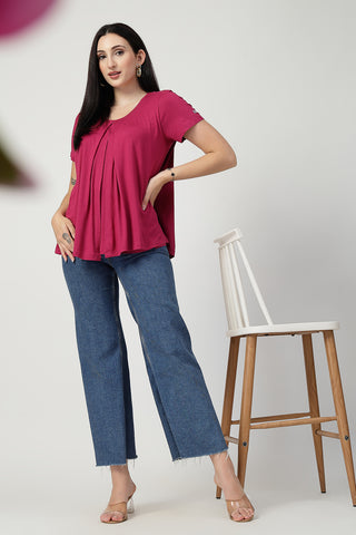 Detail shot of Viscose fabric; shows stretch and rosy-pink color/print.