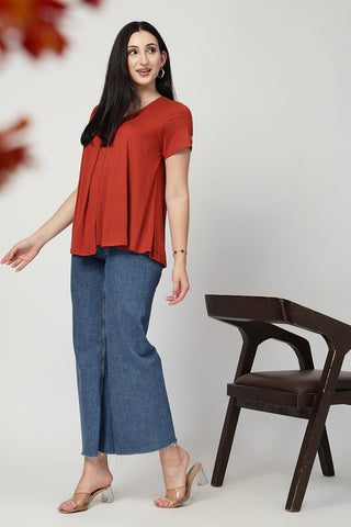 Styling detail of Rust Front & Back Pleated Zipless Nursing Top, highlighting red print and Maternity Tops design.