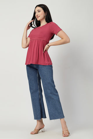 Detail shot of Viscose fabric; shows stretch and dusty-pink color/print.