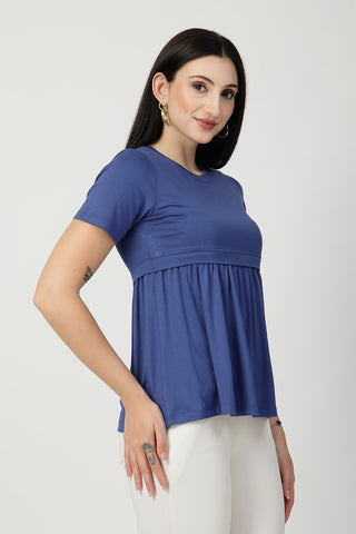 New mom wearing ditsy-blue Maternity Tops; shows flattering post-delivery fit and Zipless.