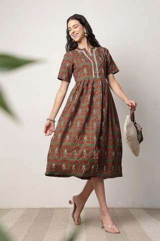 Woman wearing Mehr – The Festive Zipless Feeding Lapel Dress- Bottle Green in Green - Pre & Post Pregnancy