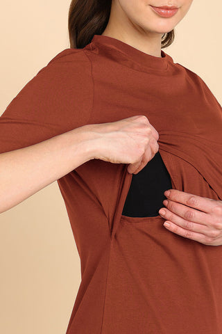 Model wearing Rust Top; garment provides coverage and fit for a changing body.