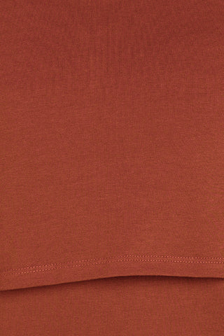 Rust Round Neck Top; neckline provides coverage and shape.