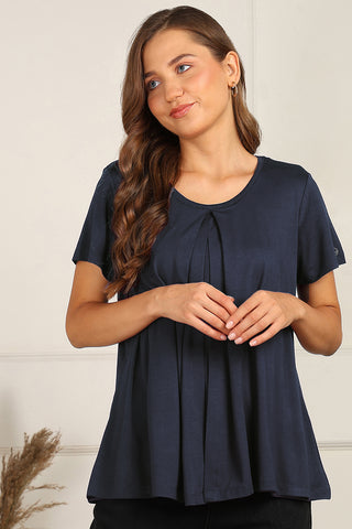 Model wearing Navy Pleated Top; offers coverage and comfortable fit for a changing body.